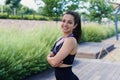 Portrait of fit young woman with jump rope in a park. Fitness female doing skipping workout outdoors on a sunny day. Royalty Free Stock Photo