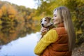 Portrait of a smiling young woman kissing a dog in a field. Dog lover stylish Royalty Free Stock Photo