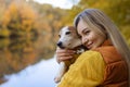 Portrait of a smiling young woman kissing a dog in a field. Dog lover stylish Royalty Free Stock Photo