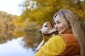 Portrait of a smiling young woman kissing a dog in a field. Dog lover stylish Royalty Free Stock Photo