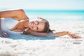 Portrait of smiling young woman laying on beach Royalty Free Stock Photo