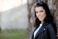 Portrait of a smiling young woman leaning against a wall Royalty Free Stock Photo