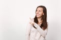 Portrait of smiling young woman in light clothes looking, pointing index finger aside up isolated on white wall Royalty Free Stock Photo