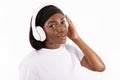 Portrait of smiling young woman listening to music in headphones Royalty Free Stock Photo