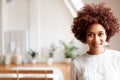 Portrait Of Smiling Young Woman In Loft Apartment