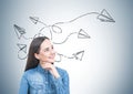 Cheerful young woman in a jeans shirt, paper plane Royalty Free Stock Photo