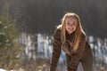 Portrait of smiling young woman with long hair outside in nature. Walk on sunny winter day Royalty Free Stock Photo