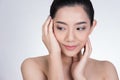 Portrait of a smiling young woman with natural make-up. beautiful asian girl standing against white background. Royalty Free Stock Photo