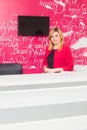 Portrait of smiling young woman with receptionist in dentist's office Royalty Free Stock Photo