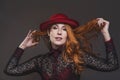 Autumn mood of beauty: smiling woman with red hat, studio portrait Royalty Free Stock Photo