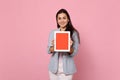 Portrait of smiling young woman in striped jacket holding tablet pc computer with blank empty screen isolated on pink Royalty Free Stock Photo