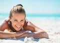 Portrait of smiling young woman in swimsuit laying on beach Royalty Free Stock Photo