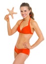 Portrait of smiling young woman in swimsuit starfish Royalty Free Stock Photo