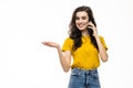 Portrait of a smiling young woman talking on mobile phone isolated over white background Royalty Free Stock Photo