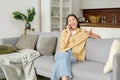 Portrait of smiling young woman talking by smartphone and looks away. Carefree charming asian lady enjoys phone Royalty Free Stock Photo