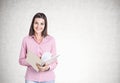 Smiling young woman, copybook, concrete