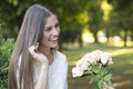 Portrait of smiling young woman who receives a gift, a bouquet o