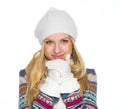 Portrait of smiling young woman in winter clothes warming hands Royalty Free Stock Photo