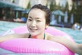 Portrait of smiling young women in the pool with an inflatable tube Royalty Free Stock Photo