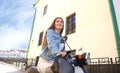 Portrait smilling beautiful girl sitting on retro scooter. Royalty Free Stock Photo