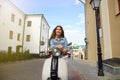 Portrait smilling beautiful girl sitting on retro scooter. Royalty Free Stock Photo