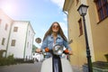 Portrait smilling beautiful girl sitting on retro scooter. Royalty Free Stock Photo