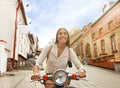 Portrait smilling beautiful girl sitting on retro scooter. Royalty Free Stock Photo