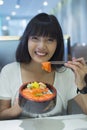 Portrait of smilling young asian woman eating japanese food Royalty Free Stock Photo