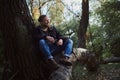 Portrait of a smoking young bearded man adventurer relaxing in the autumn forest and holding a cigarette Royalty Free Stock Photo