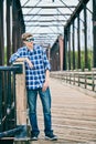 Portrait of snobbish young man standing on bridge Royalty Free Stock Photo