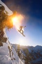 Portrait of snowboarder jumping from mountain ledge Royalty Free Stock Photo