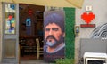 A portrait of soccer idol Armando Maradona decorates outdoor cafe in Naples, Italy.