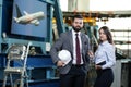 Portrait of a solid businessman with his secretary holding white hard hat, talking about factory financial report Royalty Free Stock Photo