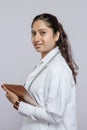 Portrait of a South Asian female doctor holding a tablet on a gray background Royalty Free Stock Photo