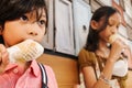 Southeast Asian children, boy and girl enjoy eating ice cream cones together at mall Royalty Free Stock Photo
