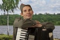 Portrait of Soviet soldier with accordion outdoors Royalty Free Stock Photo