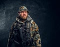 Portrait of a special forces soldier in the military camouflaged uniform, looking sideways.