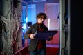 Portrait of it specialist holding hardware in hand standing in server room