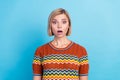 Portrait of speechless girl with short hairstyle wear striped t-shirt astonished staring open mouth isolated on blue