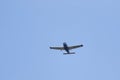 A portrait of a sport airplane flying through a blue sky. The small plane, aircraft is flying straight through the air with its Royalty Free Stock Photo