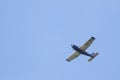 A portrait of a sport plane flying through a blue sky. The small airplane, aircraft is flying straight through the air with its Royalty Free Stock Photo