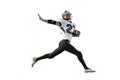 Portrait of sportive man, american football player in uniform playing, training isolated over white background Royalty Free Stock Photo