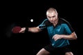 Portrait of sports man, male, athlete playing table tennis isolated on black background Royalty Free Stock Photo