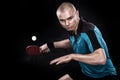 Portrait of sports man, male, athlete playing table tennis isolated on black background Royalty Free Stock Photo