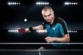 Portrait of sports man, male, athlete playing table tennis isolated on black background Royalty Free Stock Photo