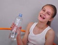 Portrait of sports teen girl with a bottle drinking water Royalty Free Stock Photo