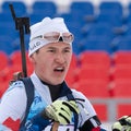 Portrait sportsman biathlete Akhtyamov Ilmir Saint Petersburg at finish after skiing, rifle shooting. Junior biathlon