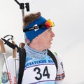 Portrait sportsman biathlete Vladislav Rusinov Khanty-Mansiysk at finish after skiing, rifle shooting. Open regional