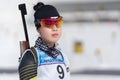 Portrait sportswoman biathlete Lee Hyunju South Korea in shooting range. Regional youth biathlon competitions East of