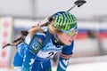 Portrait sportswoman biathlete Legostaeva Anastasia (Nyagan) at finish after skiing, rifle shooting. Junior